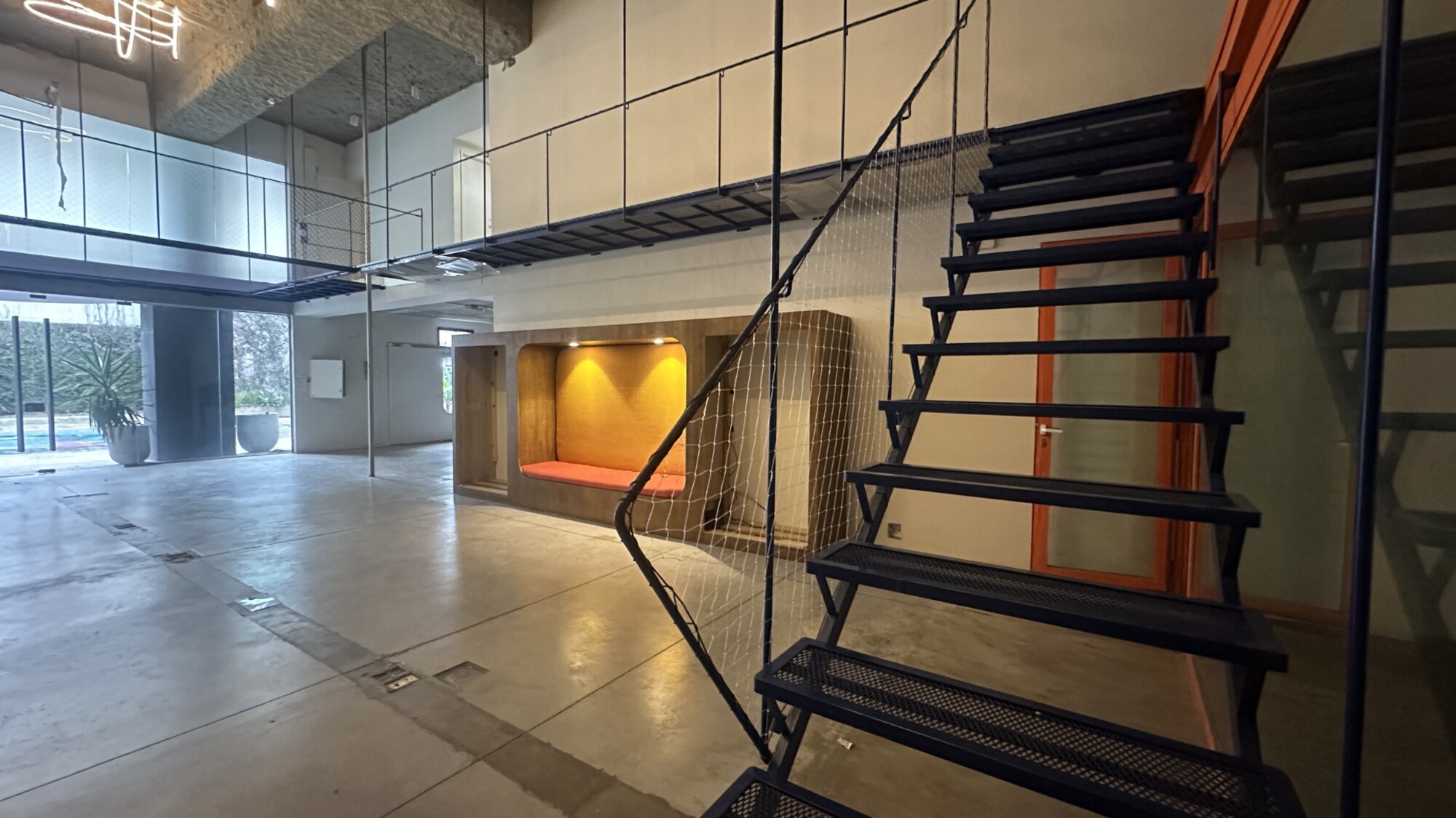 Salón en doble altura con escalera al entrepiso