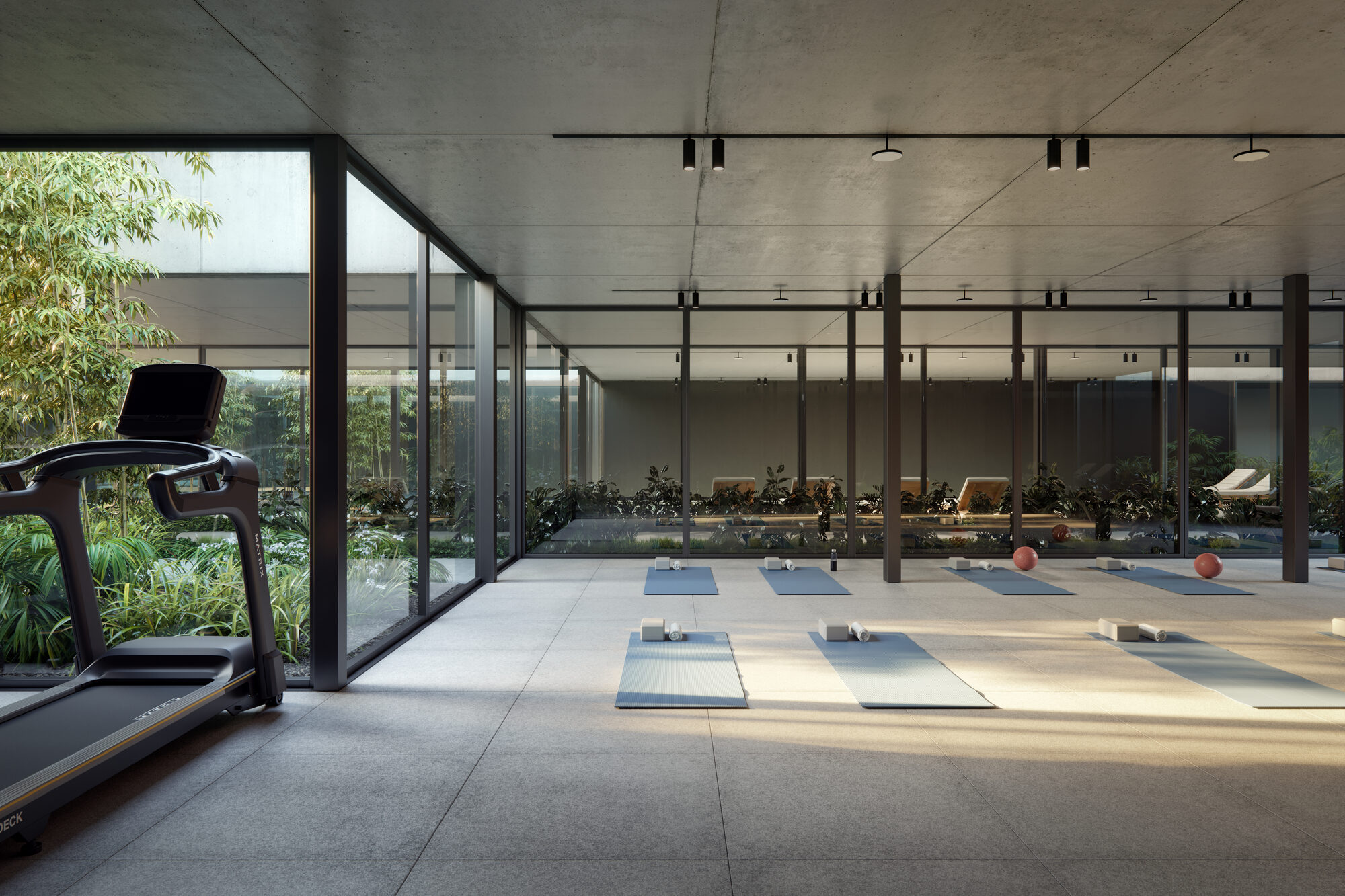 Gimnasio con vista al parque interno del edificio